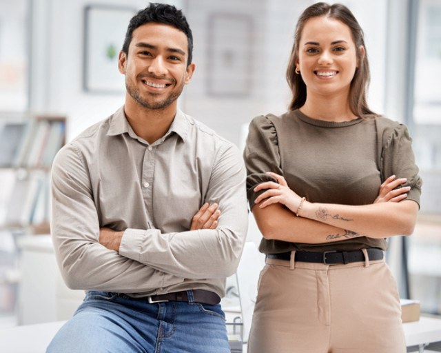smiling man and woman with arms crossed